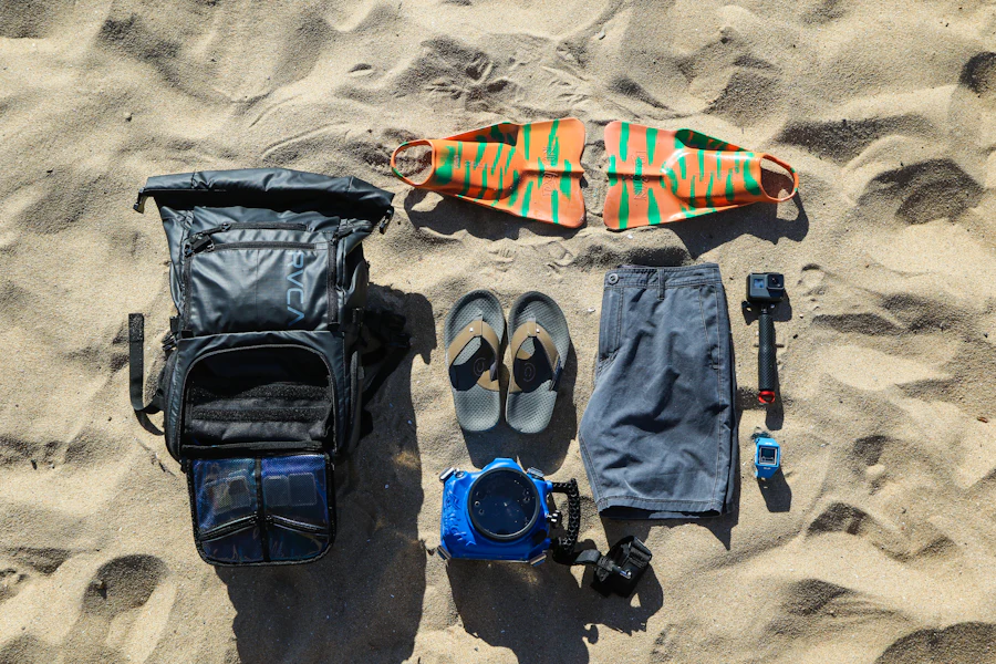 A backpack's contents laid out on the sand