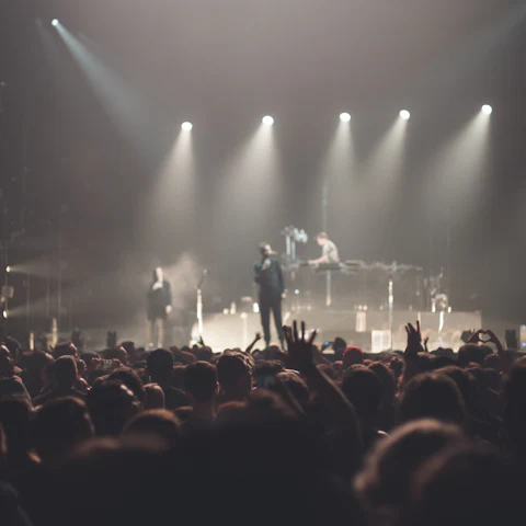 The band on a smoky, backlit stage