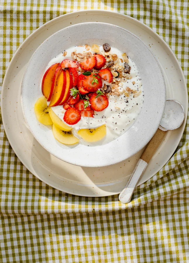 A bowl of yogurt topped with fresh fruit